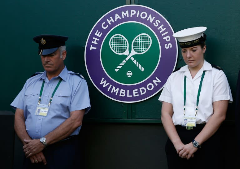 Military personnel participate in a minute's silence at Wimbledon in memory of the victims of the June 26, 2015 Tunisia attacks