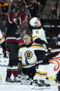 Arizona Coyotes left wing Lawson Crouse, left, celebrates his goal against Boston Bruins goaltender Jeremy Swayman, middle, as Bruins center Trent Frederic (11) reacts to the score during the second period of an NHL hockey game in Tempe, Ariz., Friday, Dec. 9, 2022. (AP Photo/Ross D. Franklin)