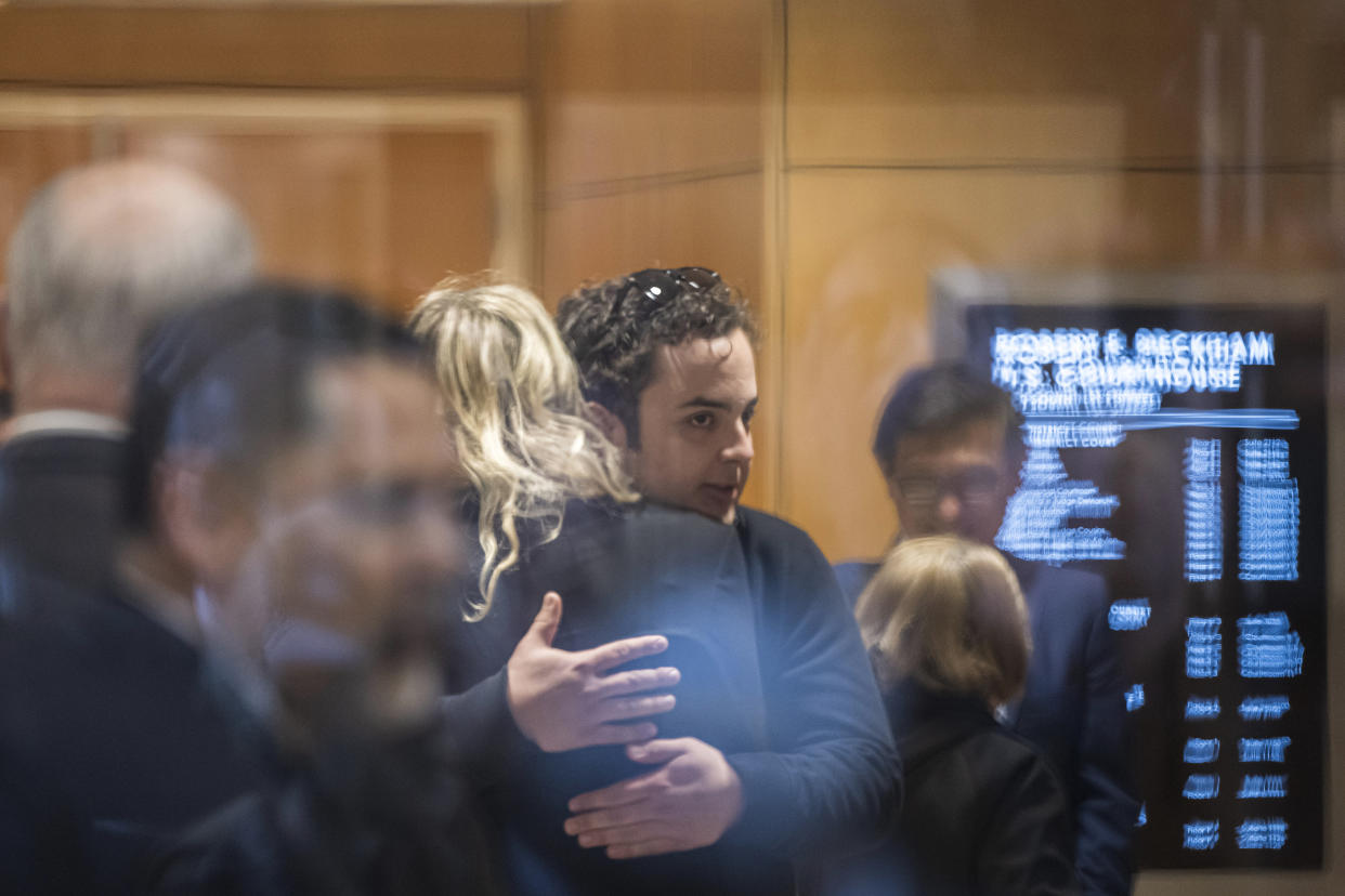 Theranos founder and CEO Elizabeth Holmes gets a hug from a supporter as she walks into federal court in San Jose, Calif., Friday, Nov. 18, 2022. A federal judge will decide whether Holmes should serve a lengthy prison sentence for duping investors and endangering patients while peddling a bogus blood-testing technology. (AP Photo/Nic Coury)