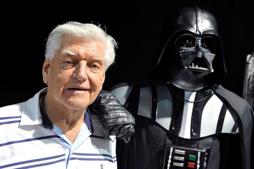David Prowse standing with Dark Vader costume