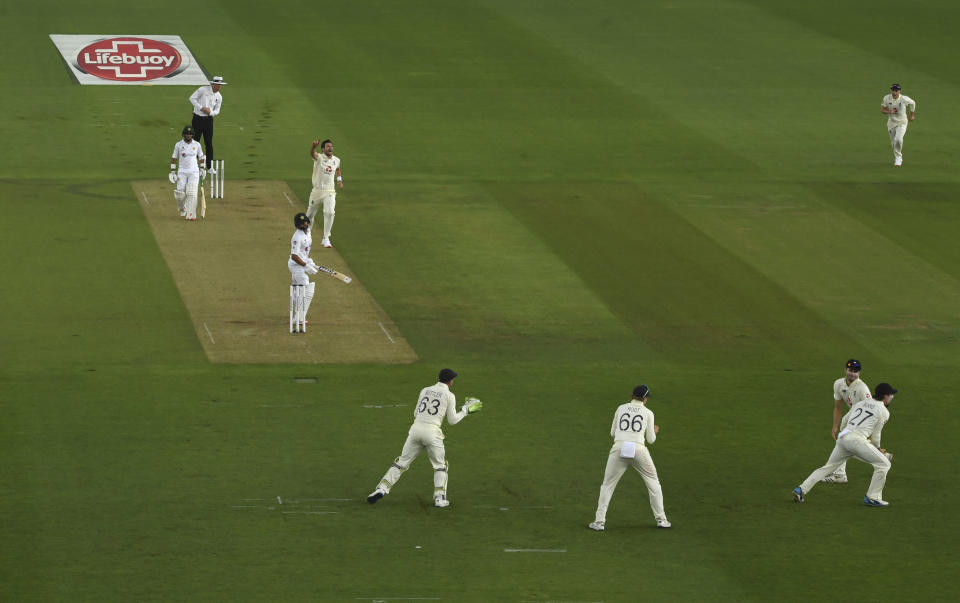 England's James Anderson, fourth left, celebrates the dismissal of Pakistan's captain Azhar Ali, third left, during the first day of the second cricket Test match between England and Pakistan, at the Ageas Bowl in Southampton, England, Thursday, Aug. 13, 2020. (Stu Forster/Pool via AP)