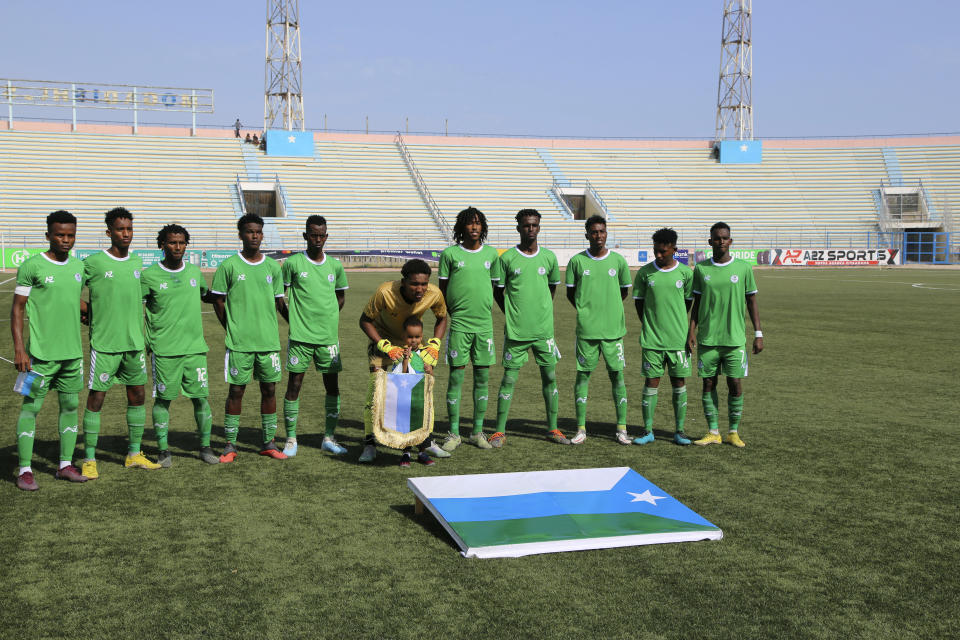 Hirshabele players pose for a team photo prior to the soccer league match between Jubaland at a stadium in Mogadishu, Somalia, Tuesday, Jan 23, 2024. A stadium in the violence-prone Somali capital is hosting its first soccer tournament in three decades, drawing thousands of people to a sports facility that had fallen into disuse and later became a military base amid civil war. (AP Photo/Farah Abdi Warsameh)