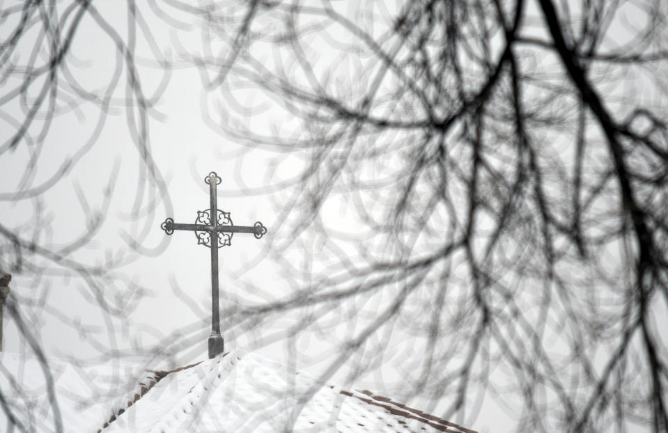 A cross sits atop a building at the Archdiocese of Denver campus on Wednesday, Jan. 18, 2023. The archdiocese is being sued by a man who alleges about 100 instances of abuse at St. Elizabeth Ann Seton Church in Fort Collins, Colo., from 1998 to 2003. The lawsuit is allowed under a 2021 state law that opened up a three-year window for people to pursue litigation for sexual abuse that happened to them as children dating as far back as 1960.(AP Photo/Thomas Peipert)