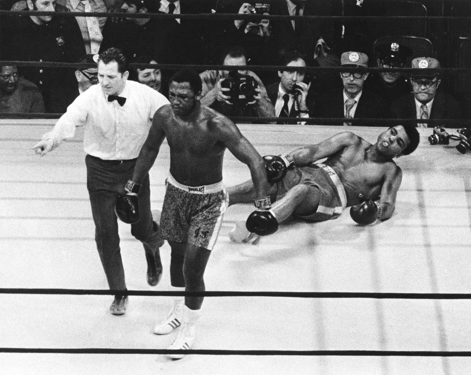 Joe Frazier is directed to a corner by referee Arthur Marcante after knocking down Muhammad Ali during the 15th round of the title bout in Madison Square Garden in New York. Frazier won the bout over Ali by decision.