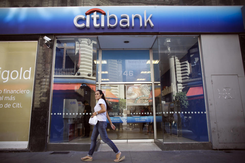 FILE - In this Tuesday, March 17, 2015, file photo, a woman walks by a Citibank branch in Buenos Aires, Argentina. Citigroup Inc. reports earnings Thursday, Oct. 12, 2017. (AP Photo/Victor R. Caivano, File)