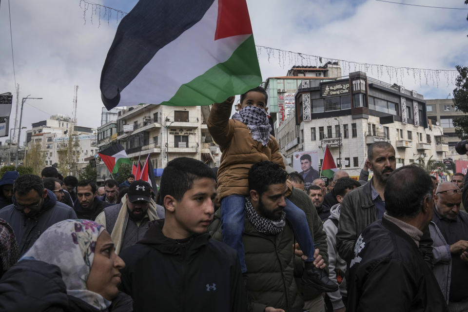 Palestinian demonstrators wave their national flag and shout slogans during a protest following the killing of top Hamas official Saleh Arouri in Beirut, in the West Bank city of Ramallah on Wednesday, Jan. 3, 2024. Arouri, the No. 2 figure in Hamas, was killed in an explosion blamed on Israel. He is the highest-ranked Hamas figure to be killed in the nearly three-month war between Israel and Hamas. (AP Photo/Mahmoud Illean)