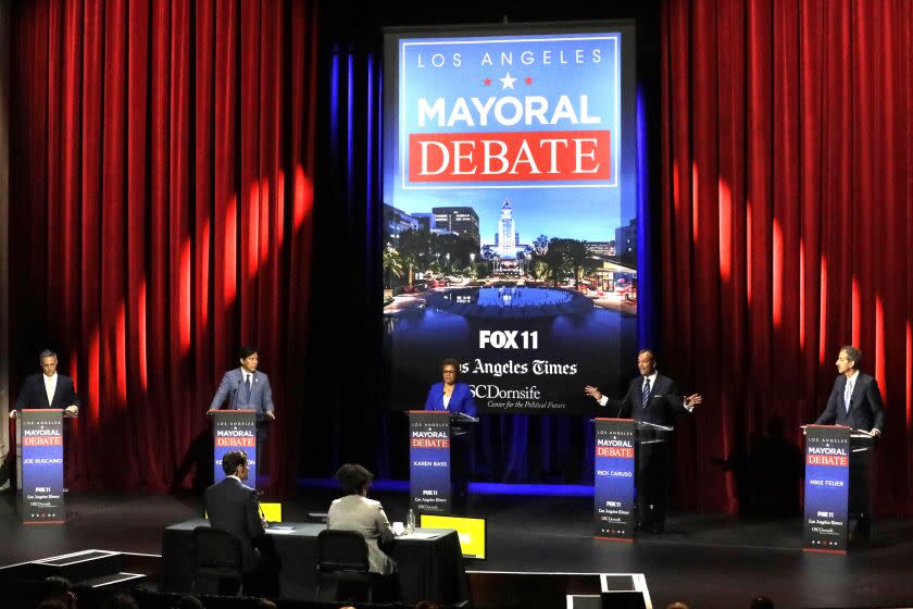 LOS ANGELES, CA - MARCH 22, 2022 - - Los Angeles City Councilman Joe Buscaino, from left, Los Angeles City Councilman Kevin de Leon, U.S. Rep. Karen Bass, businessman Rick Caruso and Los Angeles City Attorney Mike Feuer participate in a mayoral debate at Bovard Auditorium on the USC campus on March 22, 2022. (Genaro Molina / Los Angeles Times)