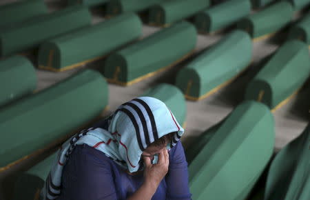 A Muslim woman cries near the coffin of her relative among the 136 newly identified victims of the 1995 Srebrenica massacre lined up for a joint burial in Potocari, Bosnia and Herzegovina July 9, 2015. REUTERS/Dado Ruvic