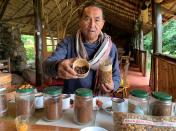 Jacques Ramarlah, a farmer and agricultural entrepreneur displays samples of Bourbon pointu coffee variety at the Kafen Drazana packaging factory in Ampefy town of Itasy region