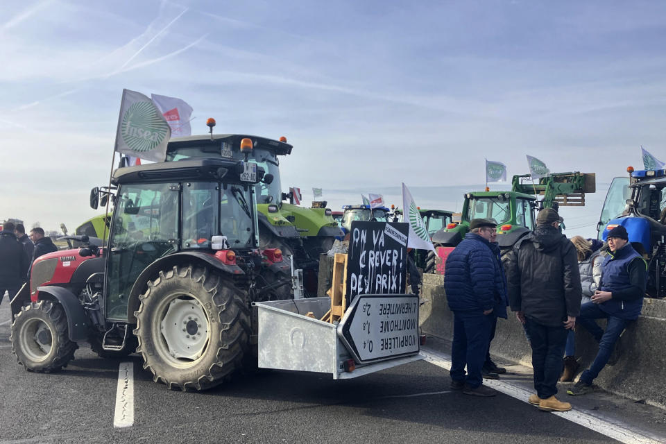 Farmers block a highway leading to Paris, Monday, Jan. 29, 2024 near Jossigny, east of Paris. Protesting farmers sought to encircle Paris with tractor barricades and drive-slows on Monday, converging in their lumbering vehicles on France's capital to pressure the government over the future of their industry, which has been shaken by repercussions of the Ukraine war. (AP Photo/Sylvie Corbet)