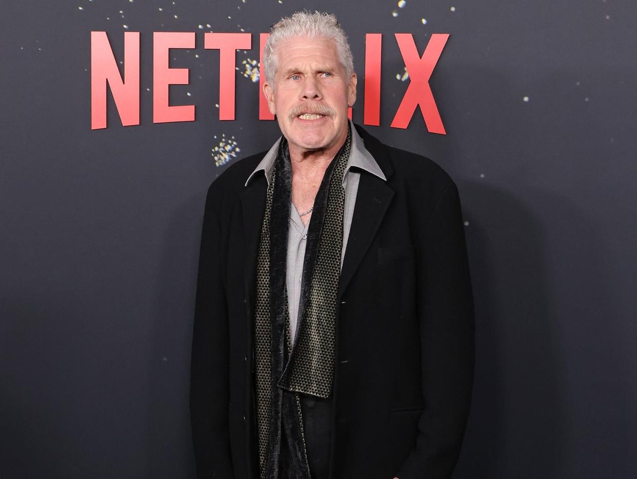 Ron Pearlman in a dark suit