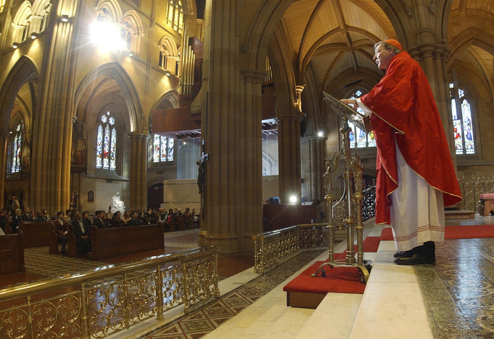 FILE - In this Sept. 14, 2004, file photo, Archbishop of Sydney, Cardinal George Pell, celebrates a special mass in Sydney's St. Mary's Cathedral. Pell was sentenced in an Australian court on Wednesday, March 13, 2019 to 6 years in prison for molesting two choirboys in a Melbourne cathedral more than 20 years ago. (AP Photo/Rick Rycroft, File)