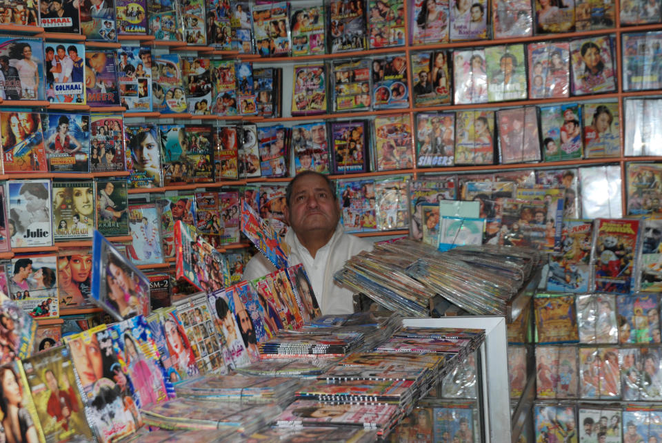 In this photo taken on Feb. 19, 2013, an owner waits for customers at his DVD shop in Abbottabad, Pakistan. Pakistan stars in "Zero Dark Thirty," from early scenes at a detention site to the dramatic closing minutes as Navy SEALs assault the hideout of bin Laden. But the Academy Award-nominated film about the hunt for the al-Qaida leader has sparked a controversy here about its portrayal of the country, and it will likely not be shown on the local big screen anytime soon. Partly, the film taps into national discomfort that bin Laden was found to be living for years near Pakistan's equivalent. (AP Photo/Aqeel Ahmed)