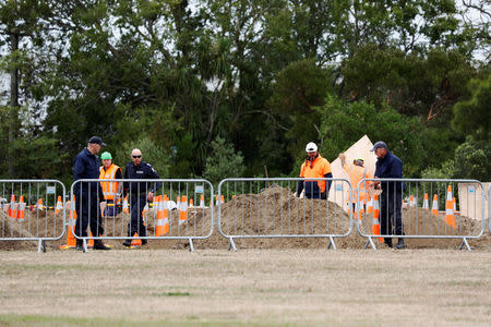 Security checks are conducted during grave digging ceremony for victims of Friday's shooting, at Memorial Park Cemetery in Christchurch, New Zealand March 18, 2019. REUTERS/Edgar Su