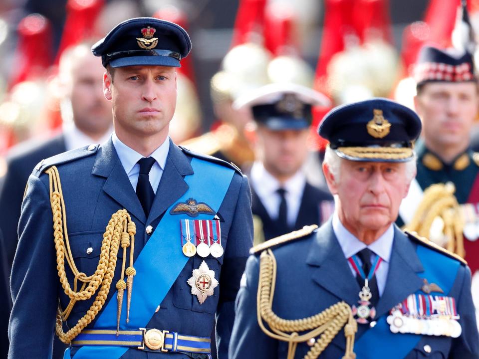 Prince William, Prince of Wales and King Charles III walk behind Queen Elizabeth II's coffin as it is transported on a gun carriage to Westminster Hall.