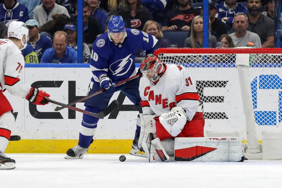 Carolina Hurricanes goaltender Frederik Andersen, of Denmark, makes a save against Tampa Bay Lightning’s Corey Perry during the third period of an NHL hockey game Tuesday, Nov. 9, 2021, in Tampa, Fla. The Hurricanes won 2-1. (AP Photo/Mike Carlson)