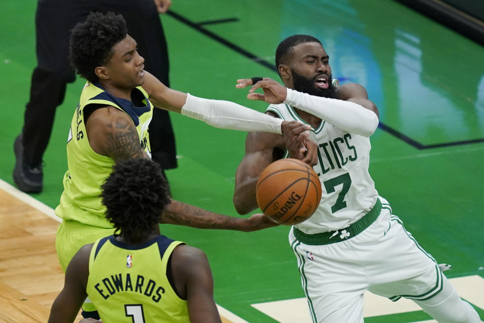 Boston Celtics guard Jaylen Brown (7) is fouled by Minnesota Timberwolves forward Jaden McDaniels, left, in the overtime period of an NBA basketball game, Friday, April 9, 2021, in Boston. (AP Photo/Elise Amendola)