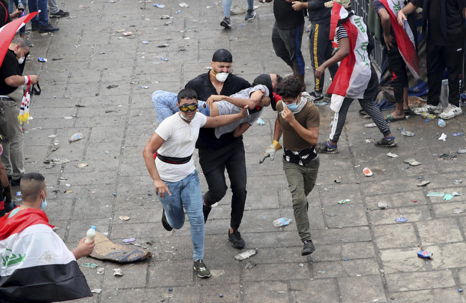 An injured protester is rushed to a hospital during a demonstration in Baghdad, Iraq, Monday, Oct. 28, 2019. Protests have resumed in Iraq after a wave of demonstrations earlier this month were violently put down. (AP Photo/Hadi Mizban)