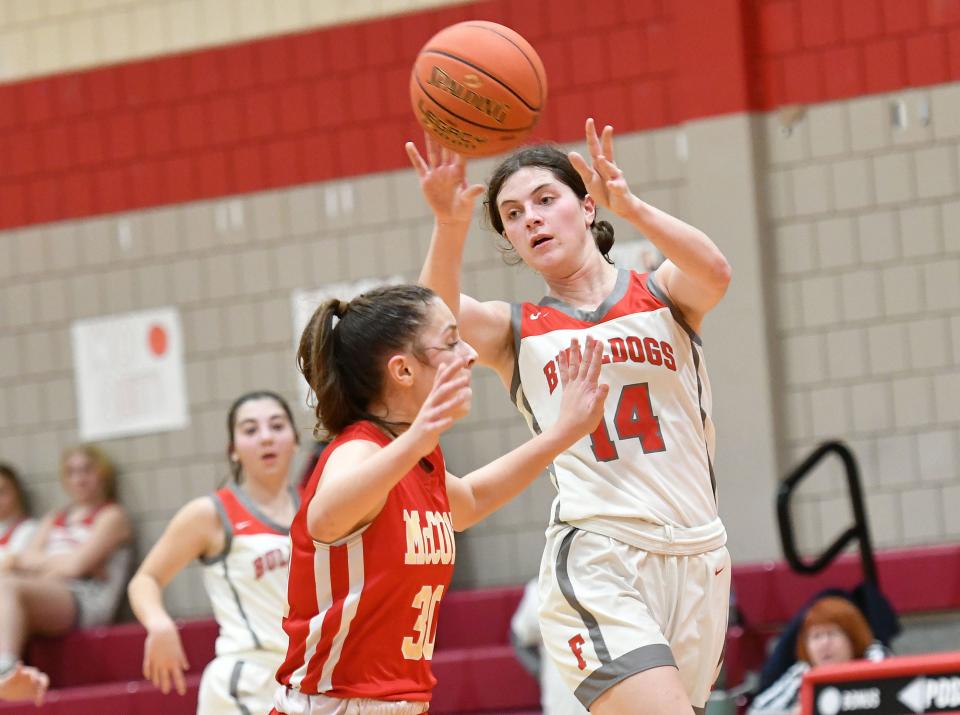 Freedom's Julz Mohrbacher passes the ball over Bishop McCort's Elle Berkebile during Friday nightÕs PIAA Class 2A playoff game at Freedom High School.