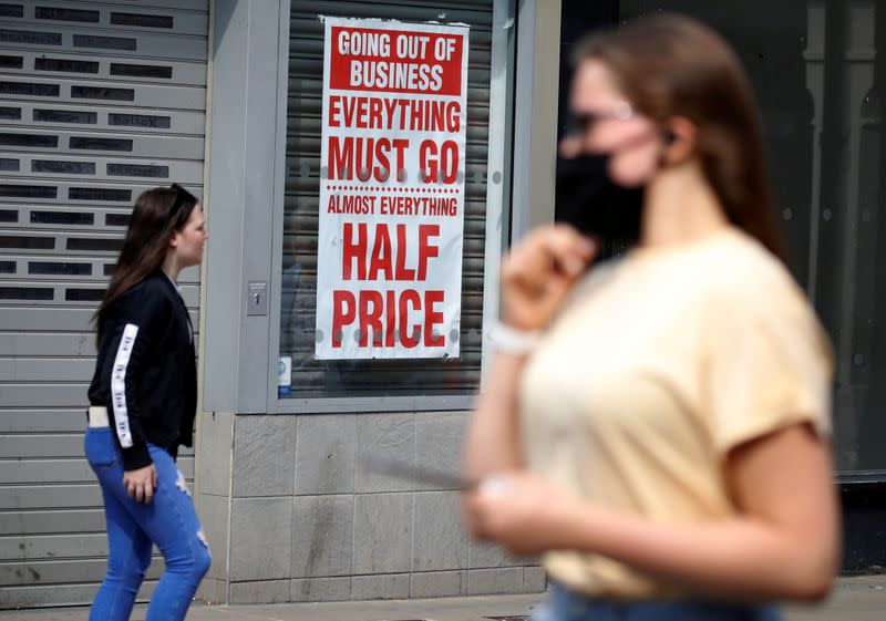 FILE PHOTO: People walk past a closed shop following the outbreak of the coronavirus disease (COVID-19) in Chester, Britain