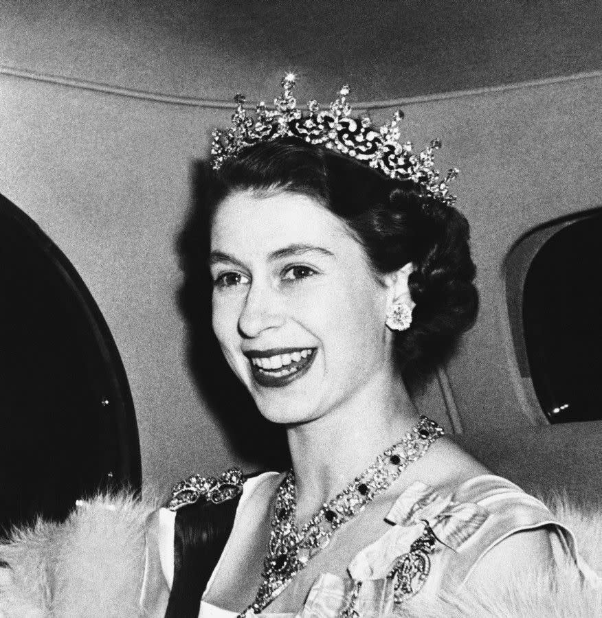 Radiant at age 23, Elizabeth arrives at the French Embassy in London to attend a state banquet on March 8, 1950.