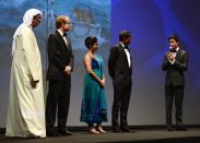 DUBAI, UNITED ARAB EMIRATES - DECEMBER 09: Artistic Director of DIFF Masoud Amralla Al Ali, guest and actors Shravanthi Sainath, Adil Hussain and Suraj Sharma on stage ahead of the "Life of PI" Opening Gala during day one of the 9th Annual Dubai International Film Festival held at the Madinat Jumeriah Complex on December 9, 2012 in Dubai, United Arab Emirates. (Photo by Andrew H. Walker/Getty Images for DIFF)