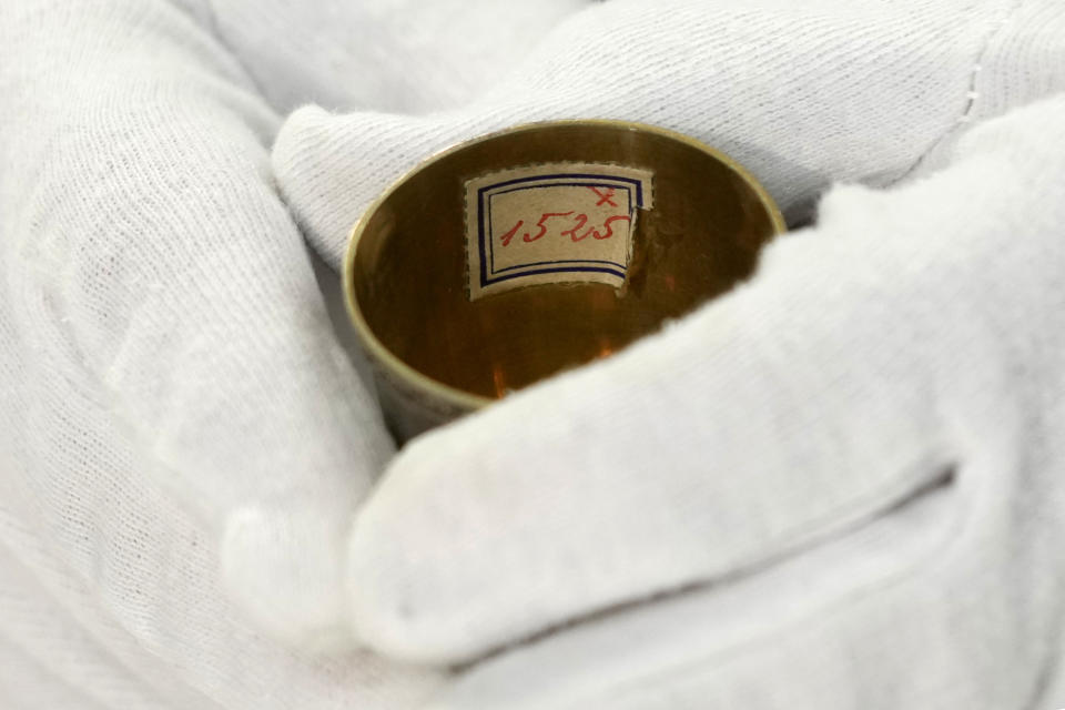 Matthias Weniger, curator of the Bavarian National Museum, holds one of the 111 silver registered objects stolen by the Nazis from the Jews during the Third Reich, in Munich, Germany, Saturday, June 10, 2023. Museum staff have made it their mission to return as many of the silver objects as possible to the descendants of the original owners. (AP Photo/Matthias Schrader)