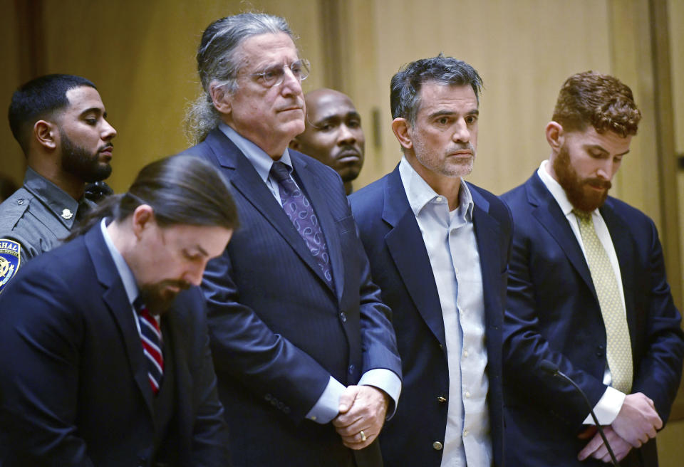 Fotis Dulos, third from left, the estranged husband of Jennifer Dulos, a missing mother of five, is arraigned on murder and kidnapping charges in Stamford Superior Court Wednesday, Jan. 8, 2020, in Stamford, Conn. Dulos had been previously charged with evidence tampering in the disappearance of Jennifer Dulos. (Erik Trautmann/Hearst Connecticut Media via AP, Pool)