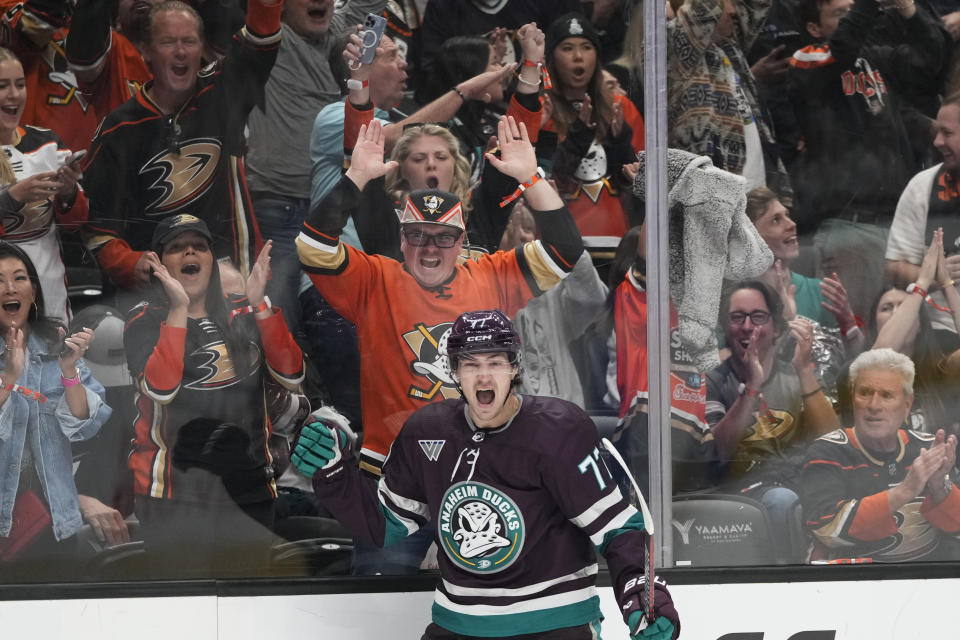 Fans cheer as Anaheim Ducks' Frank Vatrano (77) celebrates his goal against the Carolina Hurricanes during the first period of an NHL hockey game, Sunday, Oct. 15, 2023, in Anaheim, Calif. (AP Photo/Jae C. Hong)