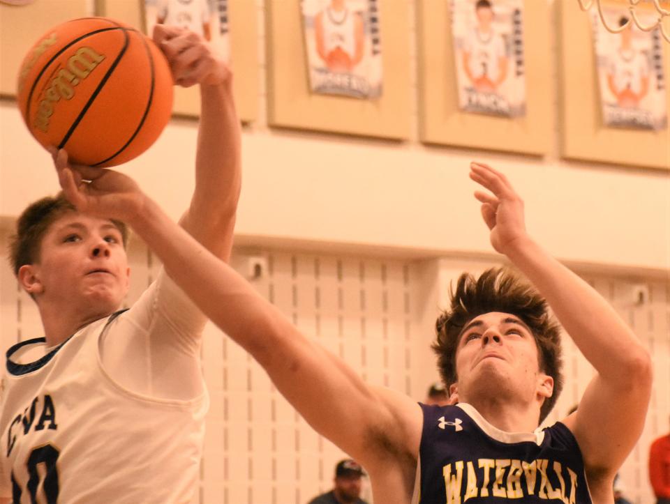 Central Valley Academy's Tom Jacquays (left) blocks a shot by Waterville Eagle Kane Patterson from behind Thursday.