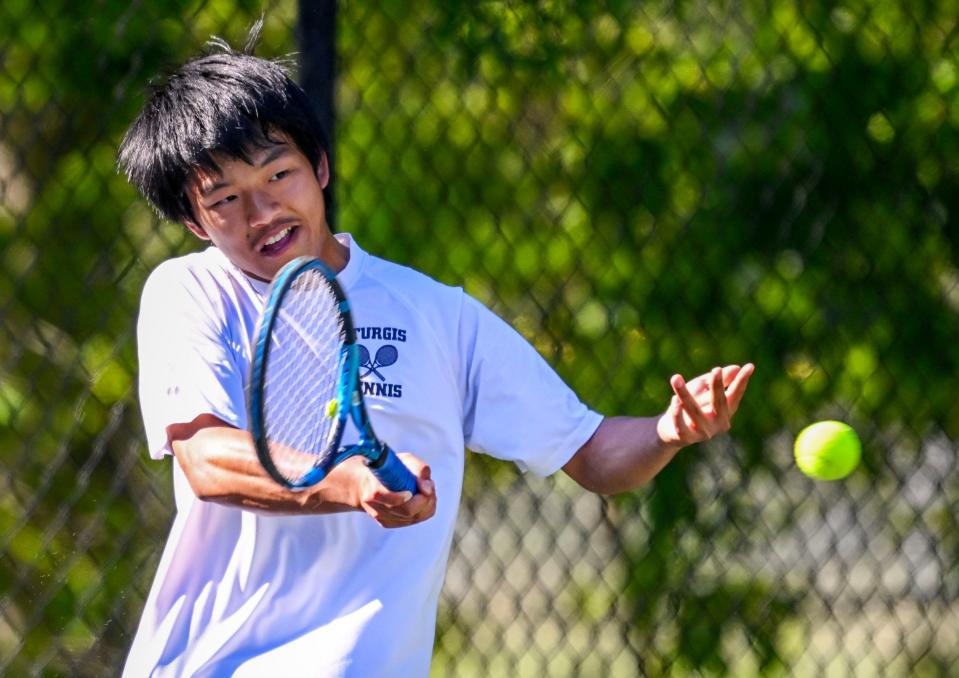 Sturgis number one singles player Ray Zhang forehands a shot against Cohasset in the Division 4 Round of 16 boys tennis match.