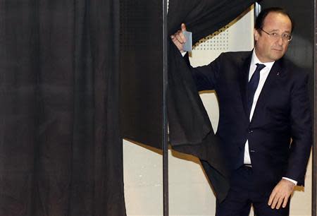 French President Francois Hollande leaves a polling booth before casting his ballot for the first round in the French mayoral elections at a polling station in Tulle, central France, March 23, 2014. REUTERS/Nicolas Tucat/Pool