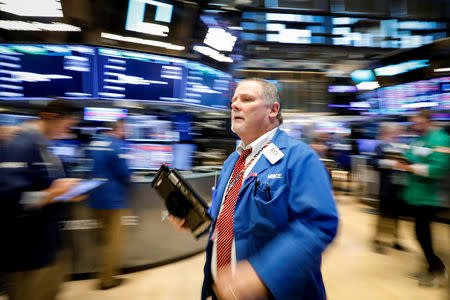 FILE PHOTO: Traders work on the floor of the New York Stock Exchange (NYSE) in New York, U.S., October 17, 2018. REUTERS/Brendan McDermid