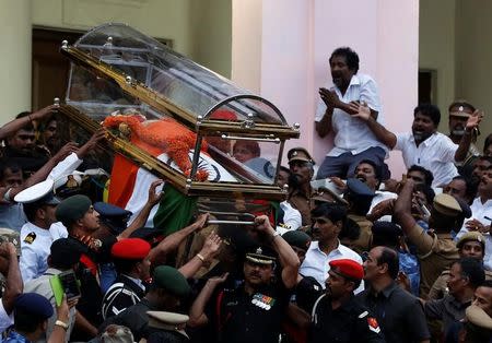 People cry as the body of Tamil Nadu Chief Minister Jayalalithaa Jayaraman is carried during her funeral procession in Chennai, India December 6, 2016. REUTERS/Adnan Abidi