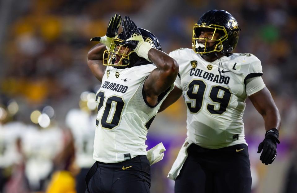 Oct 7, 2023; Tempe, Arizona, USA; Colorado Buffaloes linebacker LaVonta Bentley (20) celebrates a play with defensive lineman Shane Cokes (99) against the Arizona State Sun Devils at Mountain America Stadium.