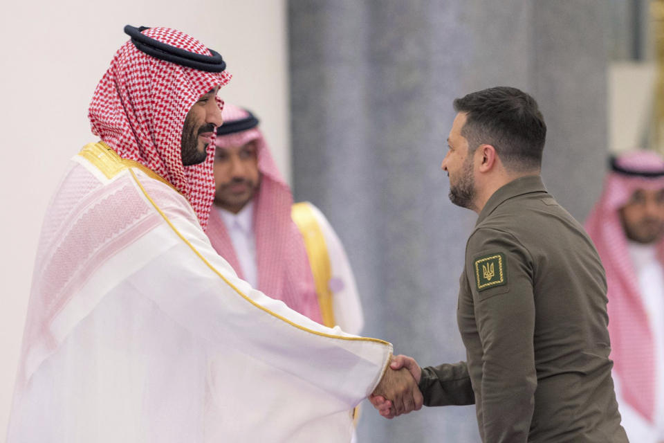 In this photo provided by Saudi Press Agency, SPA, Saudi Crown Prince Mohammed bin Salman greets Ukraine's President Volodymyr Zelenskyy, right, during the Arab summit in Jeddah, Saudi Arabia, Friday, May 19, 2023. (Saudi Press Agency via AP)