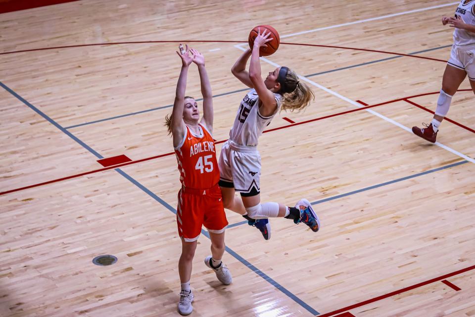 Salina Central’s Aubrie Kierscht (35) throws up a shot over Abilene’s Joy Clemence (45) in Thursday's game at Central gym.