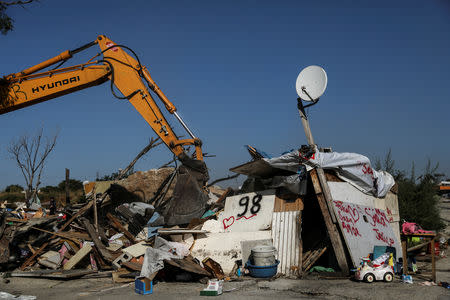 A bulldozer demolishes the remaining huts at the Roma shanty town of El Gallinero, on the outskirts of Madrid, Spain, September 27, 2018. REUTERS/Susana Vera