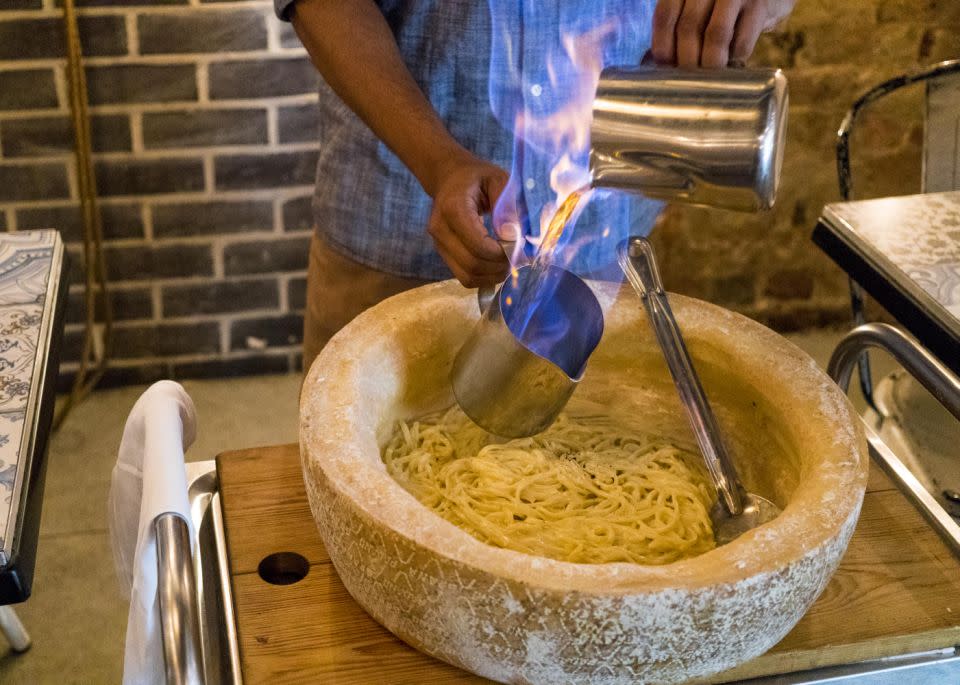 So lit. The chef pours brandy over your delicious cheese wheel and stirs up one of the yummiest meals in Sydney. Photo: Salt Meats Cheese