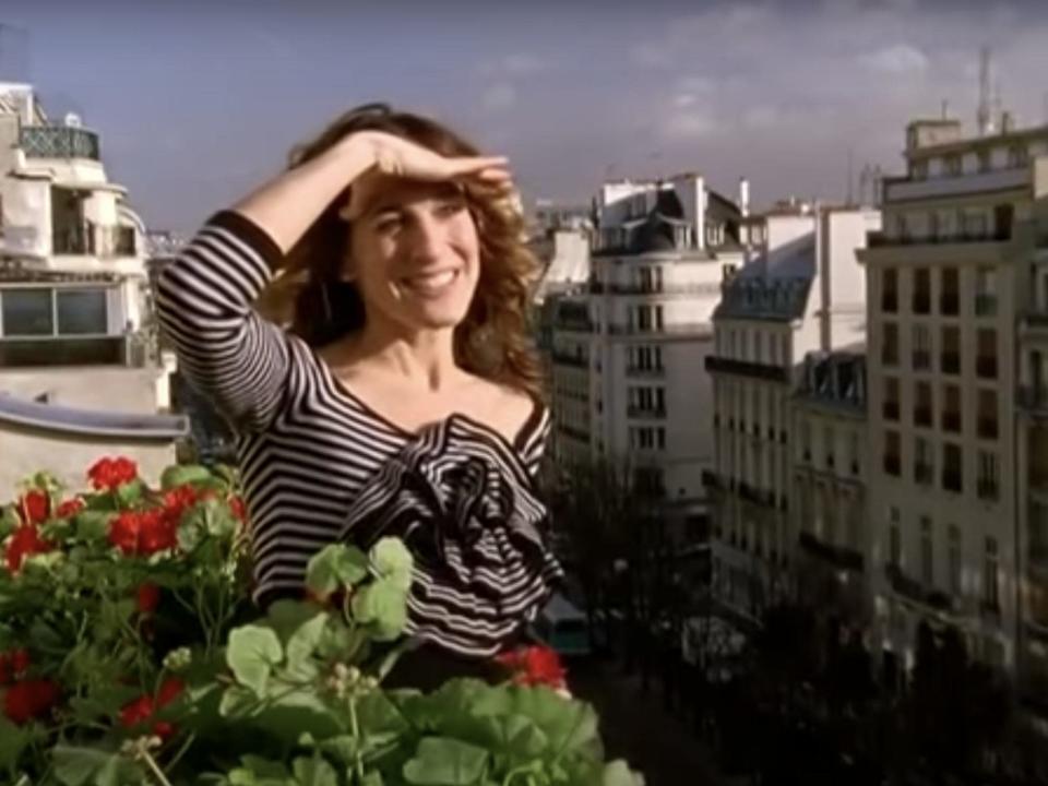 Carrie Bradshaw stands on a balcony in Paris in season six of &quot;Sex and the City.&quot;