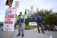 Boeing Machinists Union members Dave Hendrickson, left, and Steven Wilson, right, on the picket line at the Renton assembly plant, Friday, Sept. 13, 2024, in Renton, Wash. (AP Photo/John Froschauer)