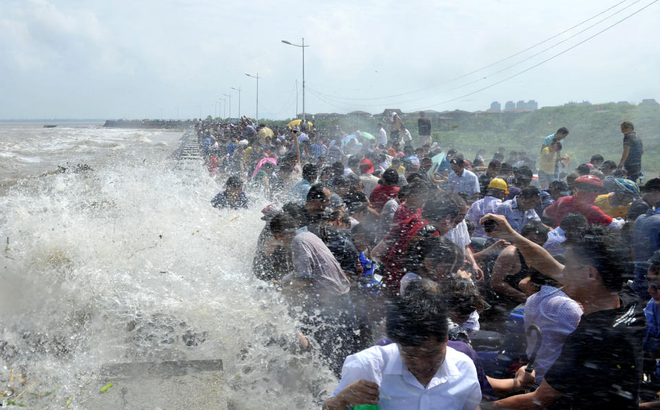 Chinese spectators hit by the tide on the Qiantang River in Haining, China.