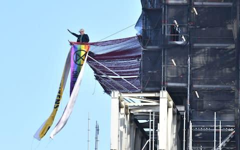 Extinction Rebellion protester scales Big Ben tower dressed as Boris Johnson - Credit: PA