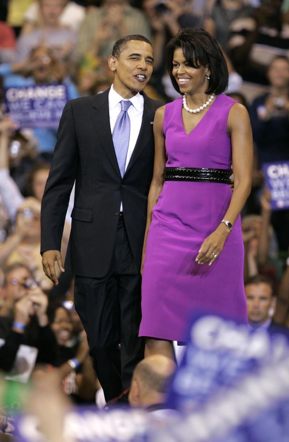 FILE - In this June 3, 2008 file photo, Democratic presidential candidate, Sen. Barack Obama, D-Ill., arrives with his Michelle Obama to speak at a primary night rally in St. Paul, Minn. Unlike some past first ladies who favored one or two big-name designers, Mrs. Obama has spread her fashion choices among a huge stable of them — often promoting lesser-known names, and taking care to promote American designers at such high-profile events as inaugurations, conventions and state dinners. (AP Photo/Morry Gash)