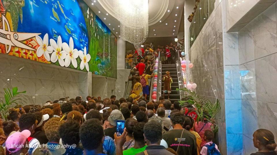 Excited shoppers in Honiara are seen making their way up an escalator for the first time. Source: Micah Alvince/ Supplied