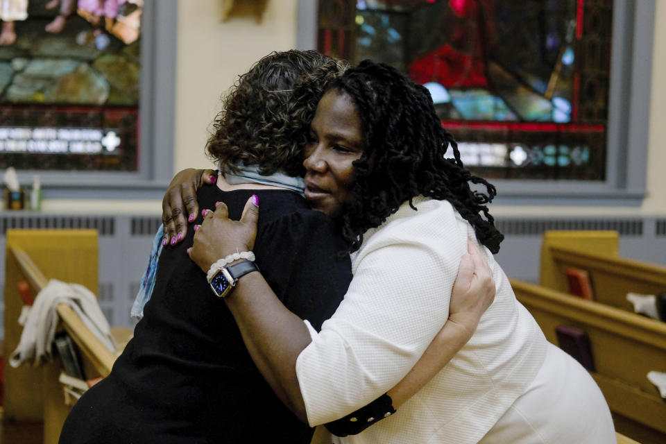 Misty Lammons, a member of Turning Point United Methodist Church in Trenton, N.J., hugs Beth Stroud during a service on Sunday, May 12, 2024. Stroud was defrocked from her job as a United Methodist pastor in Philadelphia twenty years ago. In a church trial, she was found guilty of violating Christian teaching because she acknowledged living in a committed relationship with another woman. Earlier this month, delegates at a United Methodist conference struck down longstanding anti-LGBTQ bans and created a path for Stroud and other clergy ousted because of them to seek reinstatement. (AP Photo/Luis Andres Henao)