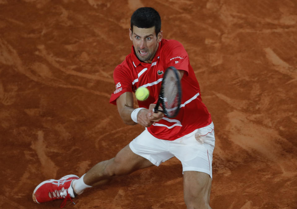 Serbia's Novak Djokovic plays a shot against Greece's Stefanos Tsitsipas in the semifinal match of the French Open tennis tournament at the Roland Garros stadium in Paris, France, Friday, Oct. 9, 2020. (AP Photo/Christophe Ena)