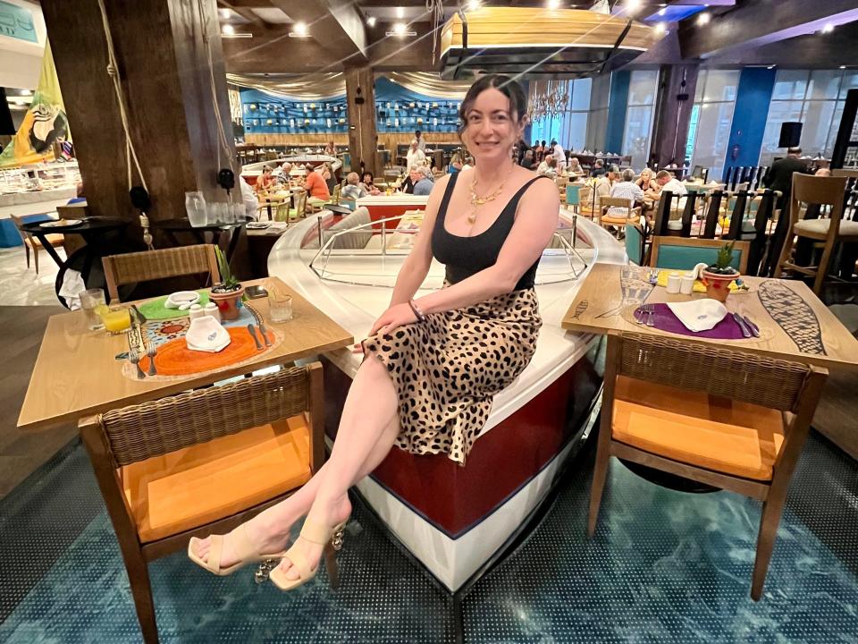 simone sitting on a speedboat table in a restaurant at Margaritaville cancun