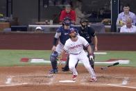 Texas Rangers' Charlie Culberson, New York Yankees catcher Kyle Higashioka and umpire Lew Williams, right rear, watch the flight of Culberson's solo home run in the third inning of a baseball game in Arlington, Texas, Wednesday, Oct. 5, 2022. (AP Photo/Tony Gutierrez)