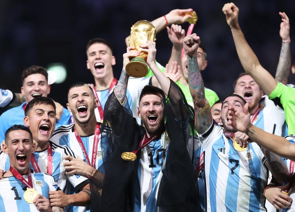 Lionel Messi lifts the Fifa World Cup trophy after Argentina’s penalty shootout win over France at Lusail Stadium on 18 December 2022 in Lusail City, Qatar (Getty)